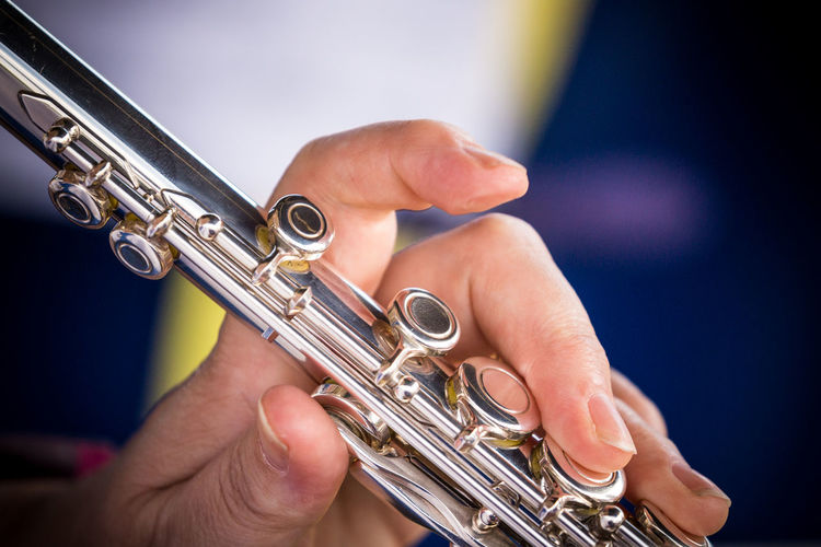 Close-up of hands playing musical instrument