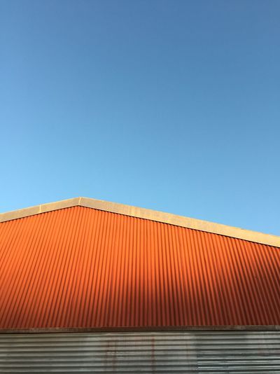 High section of built structure against clear blue sky