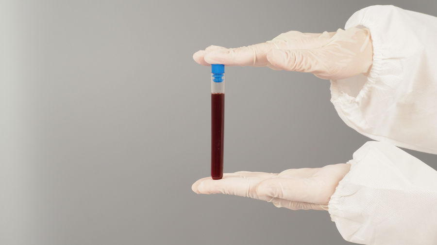 Midsection of woman holding thermometer