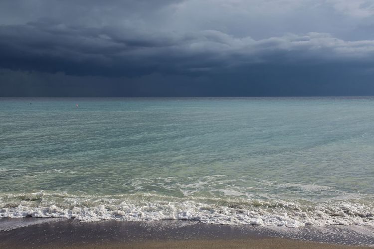 Scenic view of sea against stormy sky