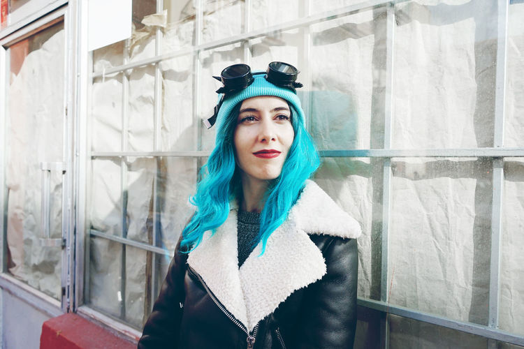 Close-up of fashionable woman with dyed blue hair in city