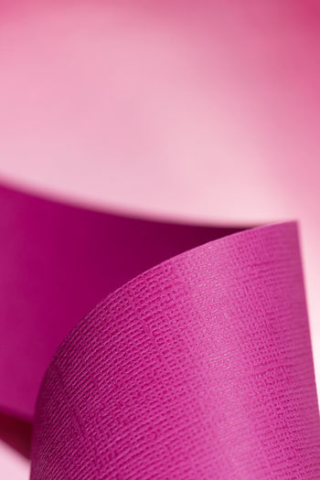 Pink paper design on color background