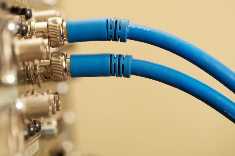 Close-up of blue cables connected to amplifier