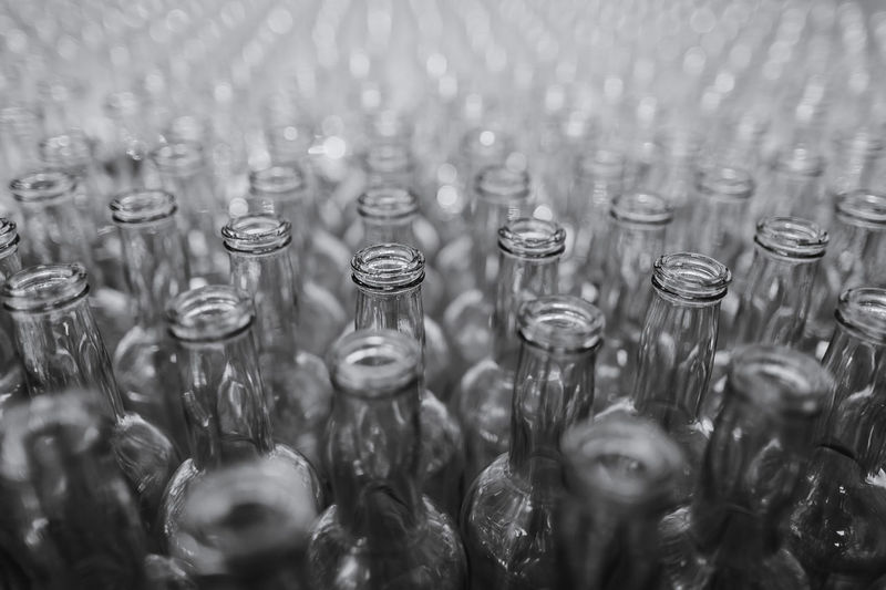 A lot of glass bottles standing close to each other
