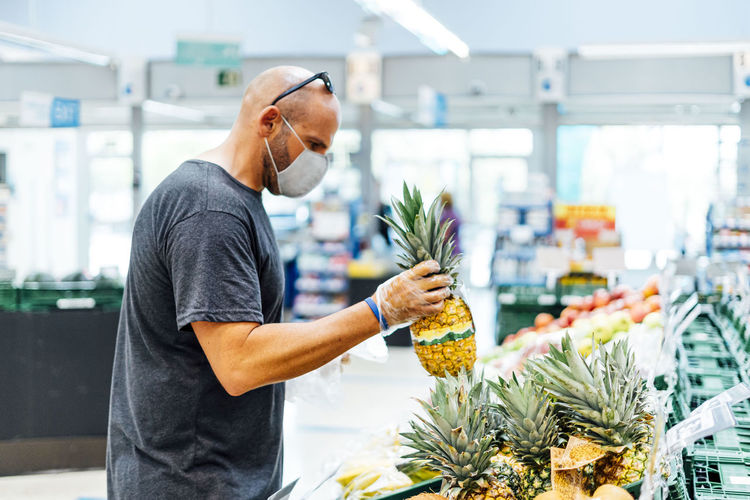 Man buying fresh fruit in supermarket