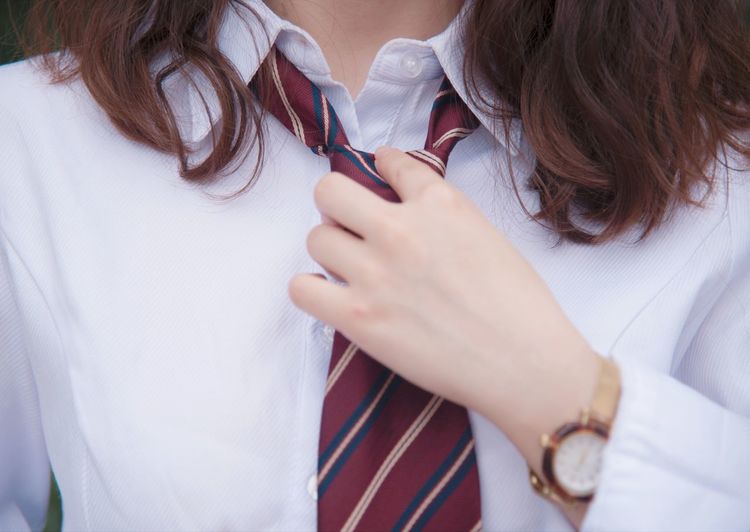 Midsection of woman wearing tie