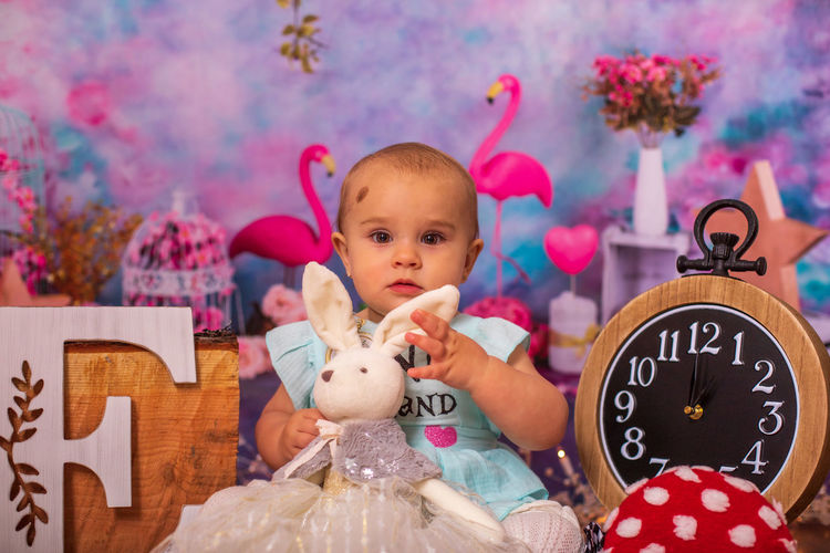 Close-up of baby amidst birthday decoration