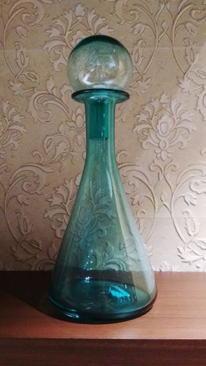 Close-up of glass bottle on table at home