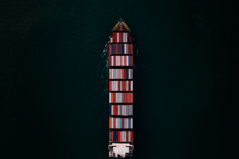 Container ship transporting large cargo logistic import export goods internationally worldwide 