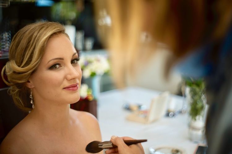 Beautiful bride sitting at table during wedding