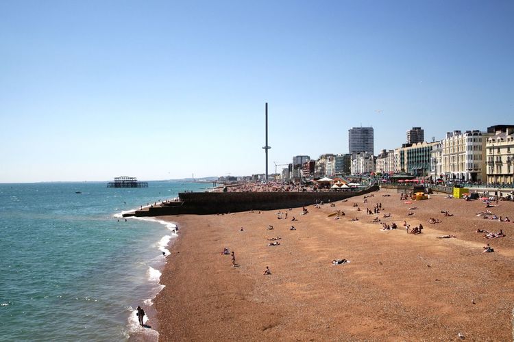 View of beach and buildings against sky