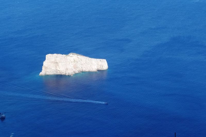 High angle view of rock by sea