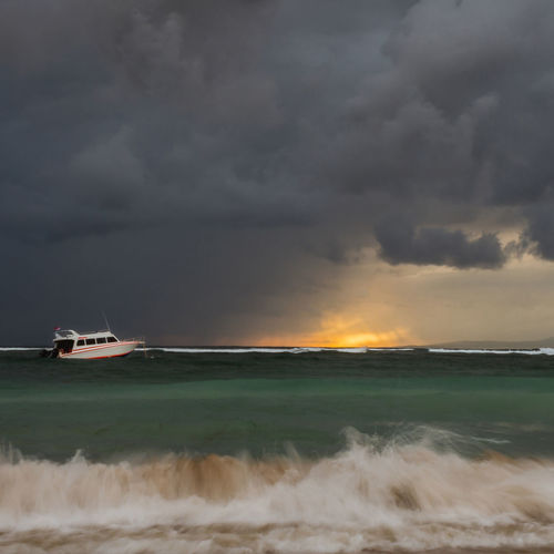 Scenic view of sea against storm clouds