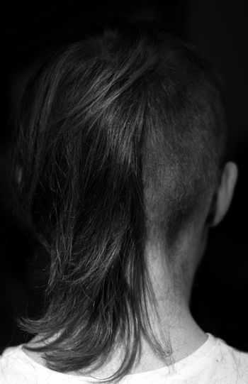 Woman with hair against black background