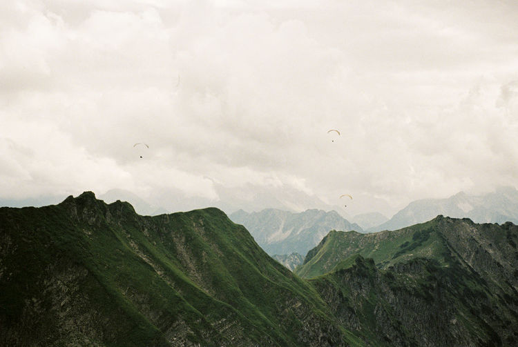 Scenic view of paragliders in the mountains near oberstdorf. shot on 35mm kodak portra 800 film.