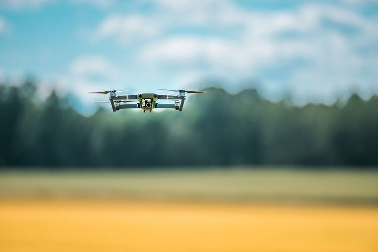 Close-up of mavic pro flying against sky