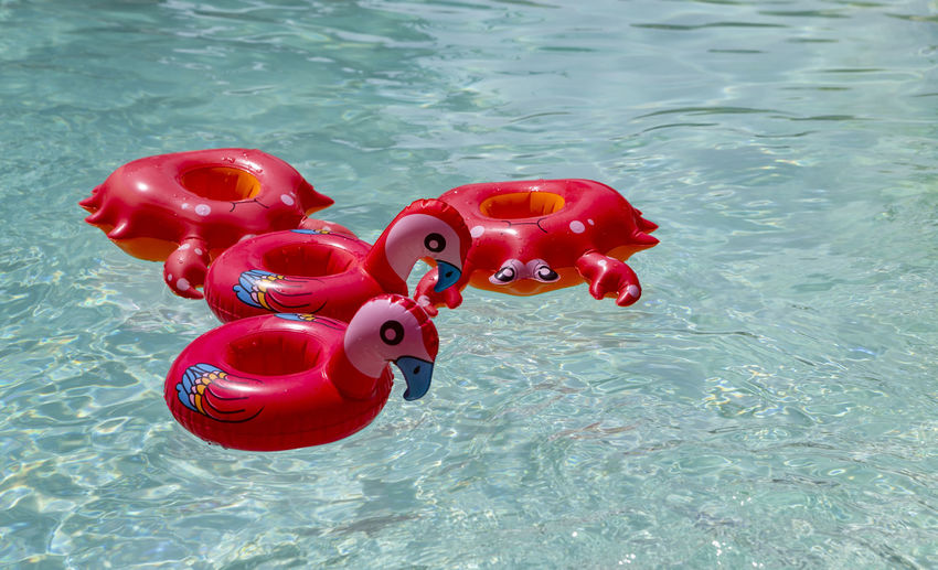 High angle view of red toy floating on swimming pool