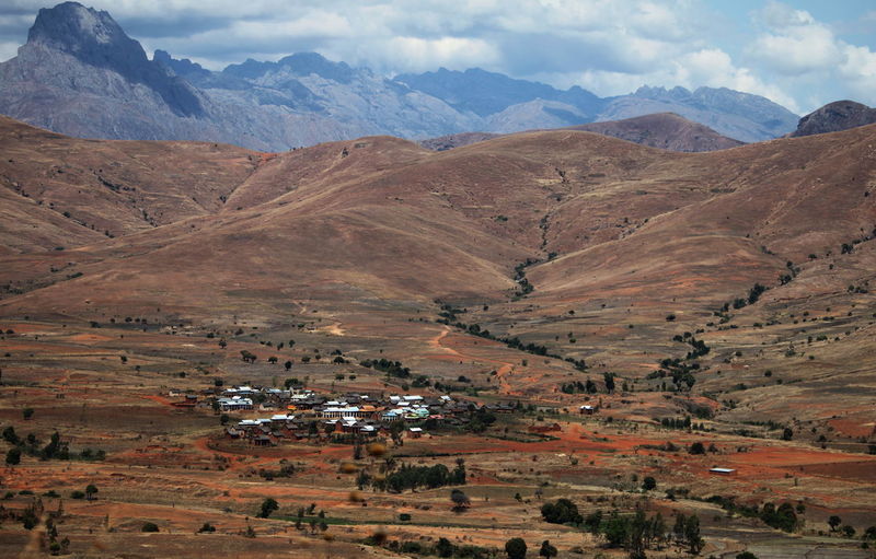 High angle view of land and mountains against sky