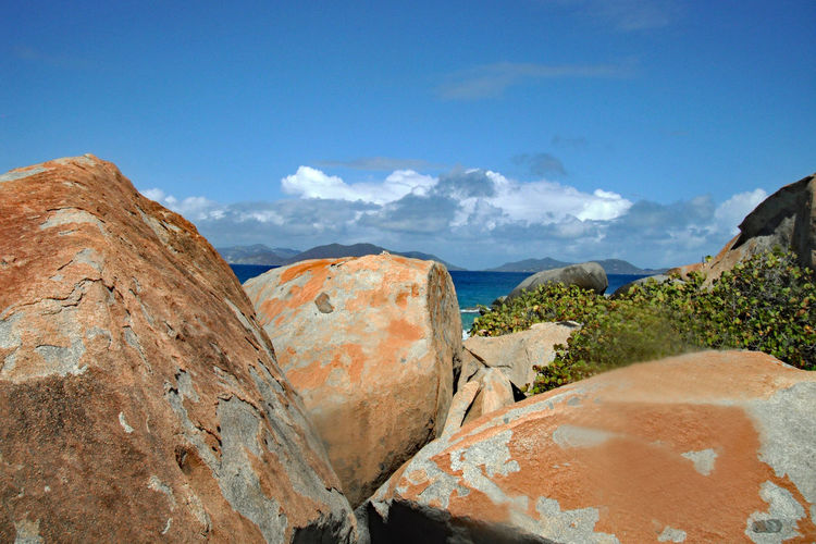 Panoramic view of rocks and mountains against blue sky
