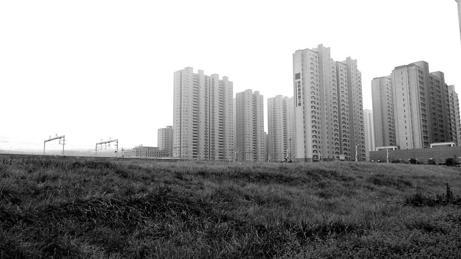 Modern buildings in city against clear sky