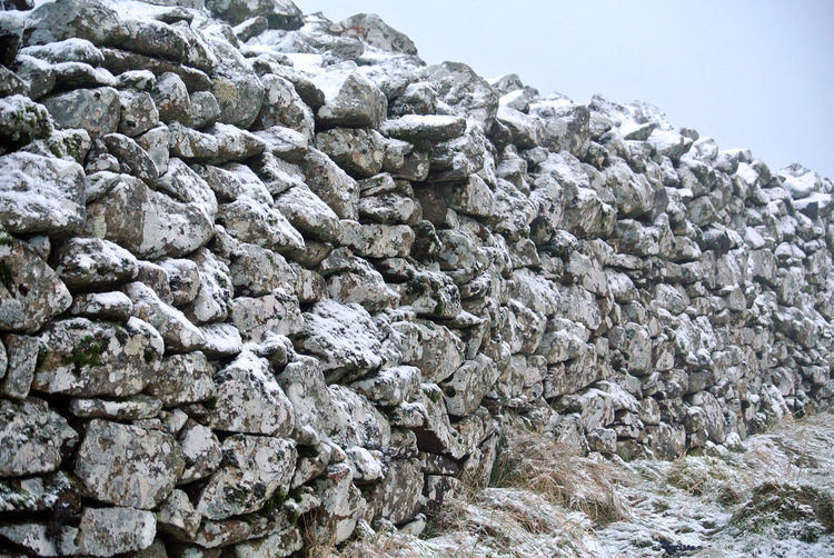 Snow dusted high dry stone wall