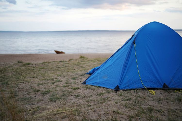 Tent on beach against sky