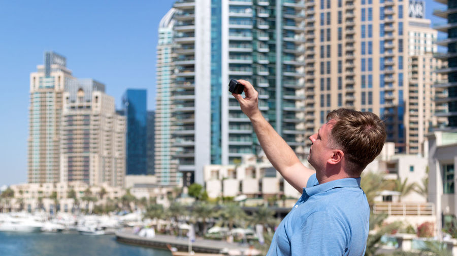 Man standing by buildings in city