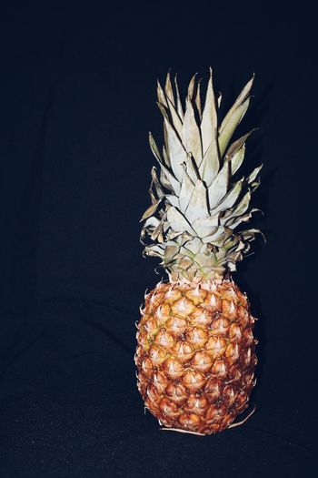 Close-up of orange on table against black background