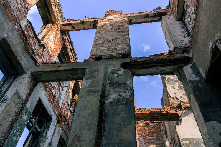 Low angle view of old ruins against sky