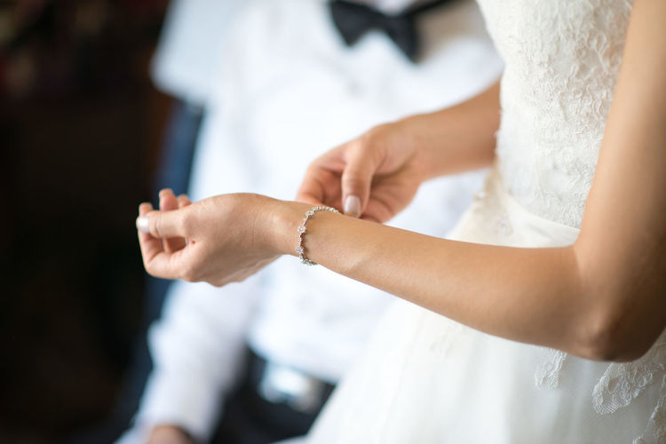 Midsection of bride wearing bracelet during wedding