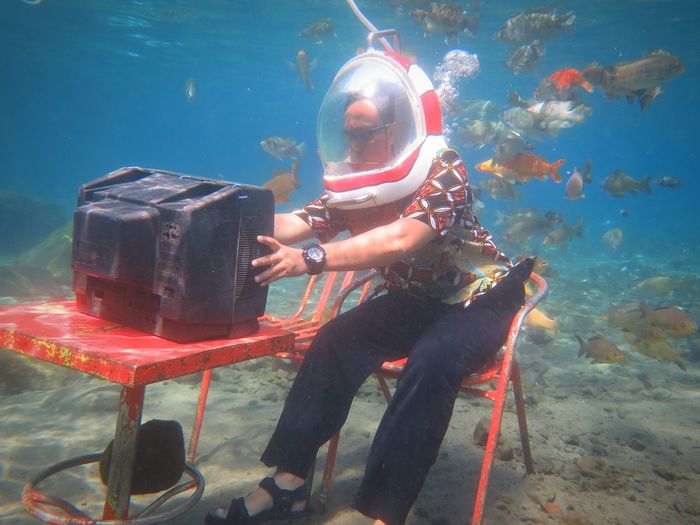 Man watching tv in sea