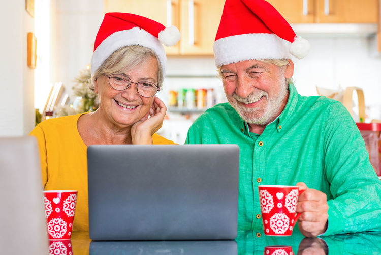 Portrait of senior man using laptop at home