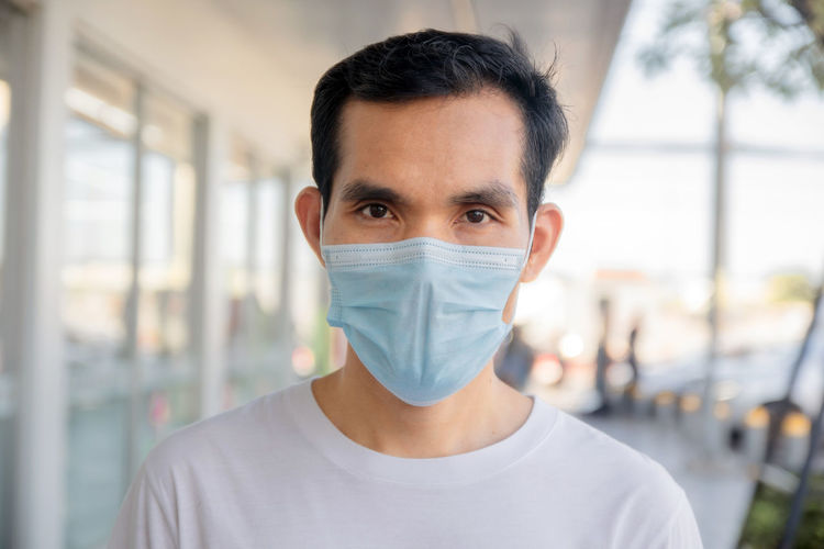 Portrait of man wearing mask standing outdoors