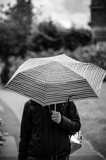 Man holding umbrella on rainy day