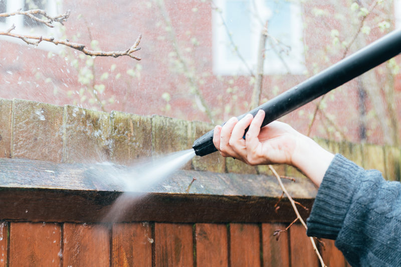 Cleaning of wood fence with pressure washer