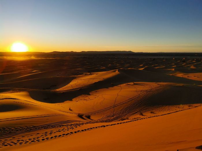 Aerial view of desert against sky during sunset