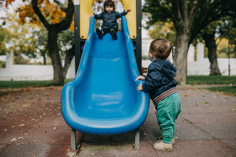 Bother and sister playing in playground