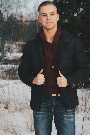 Portrait of young man standing in winter