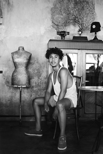 Portrait of confident man sitting on chair
