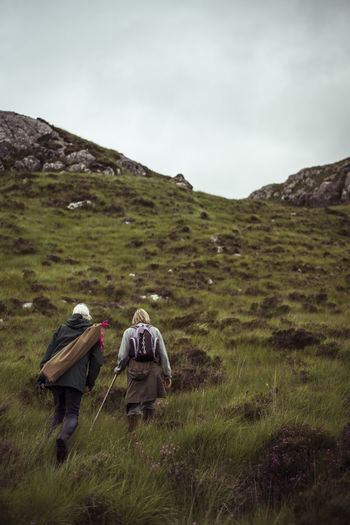 Two retired women hike up remote mountain