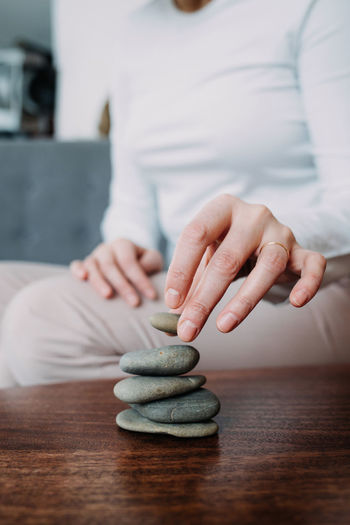 A woman collects a cairn, the concept of calmness and meditation.