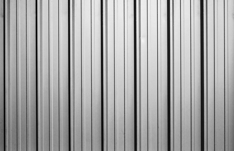 Corrugated white and black metal sheet texture background