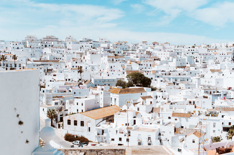 Village of white houses against blue sky in southern spain
