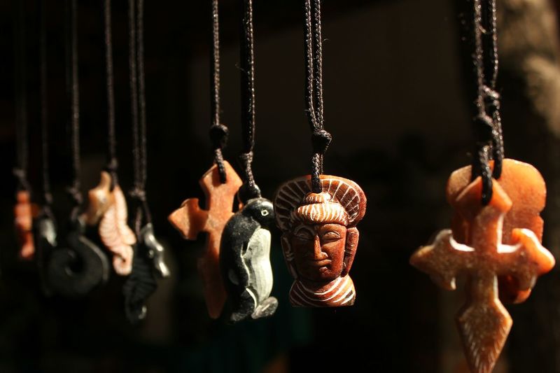 Close-up of various lockets hanging at market stall