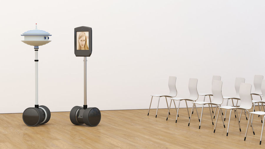 Woman on tablet screen in empty conference room with robot