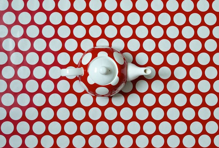 Directly above view of tea pot on polka dot table