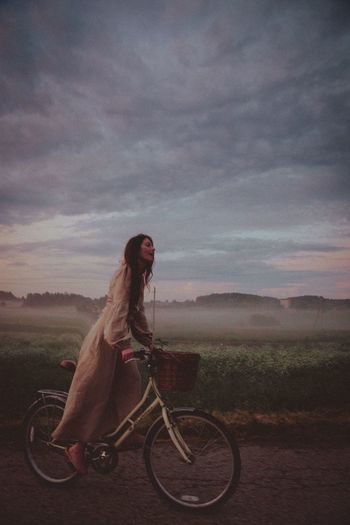Woman riding bicycle on field