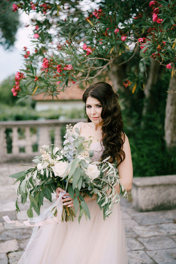 Portrait of young woman with bouquet
