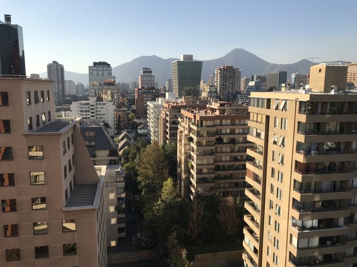 Buildings in city against clear sky