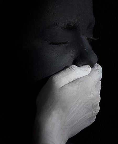 Close-up of human hand against black background